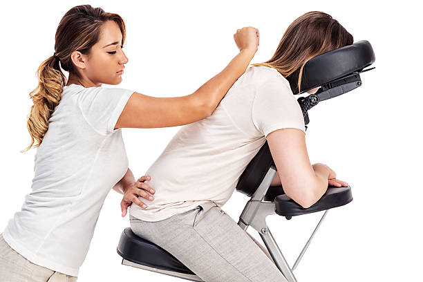Person relaxing in massage chair as professional LMT gives relaxing massage